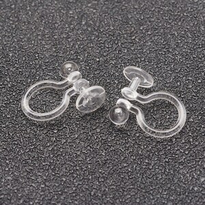 May include: Two clear plastic earring clips. The clips are designed to hold earrings in place without piercing the ear.