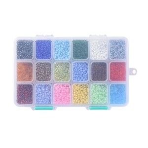 May include: A clear plastic storage box with 16 compartments filled with various colours of seed beads. The beads are arranged in rows and columns.