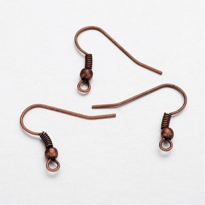 May include: Two copper earring hooks with a spring and a small ball at the end.