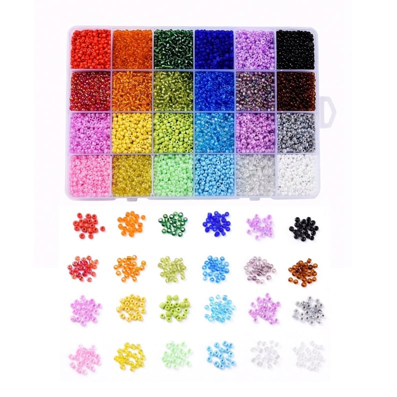 May include: A clear plastic storage box filled with 36 small containers of colorful seed beads. The beads are arranged in rows and columns, with each container holding a different color. The box is open and the beads are spilling out onto a white surface.