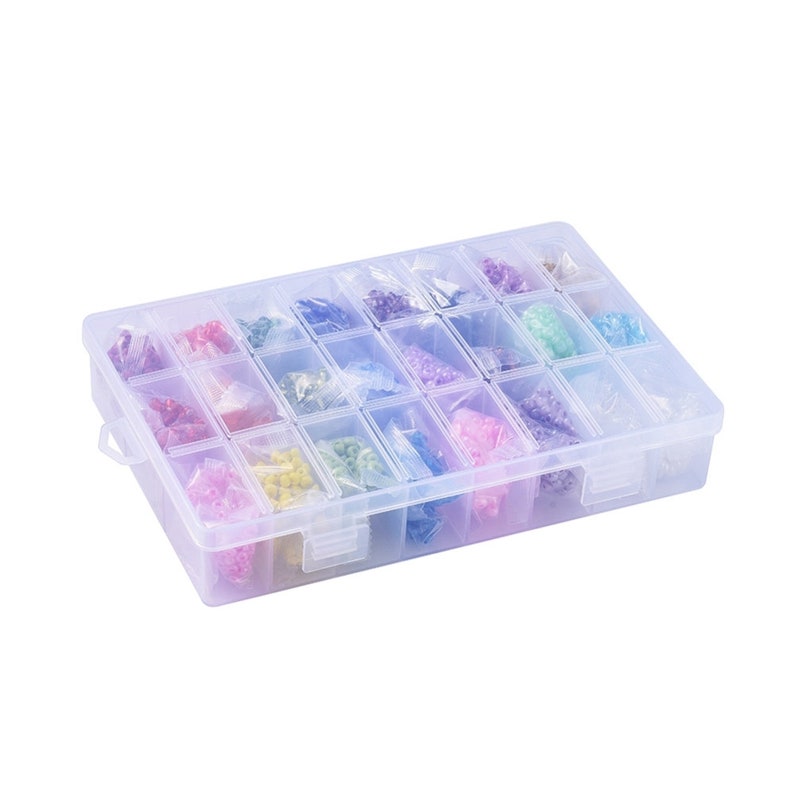 May include: A clear plastic storage box with 24 compartments filled with colorful beads. The box has a hinged lid and a latch.