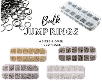 May include: Bulk jump rings in six sizes, over 1,000 pieces, in gold, silver, and gunmetal finishes. The jump rings are organized in clear plastic containers with multiple compartments.