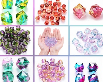 May include: Assortment of faceted glass beads in various colors, including green, purple, red, pink, and iridescent. The beads are arranged in groups on a white background.