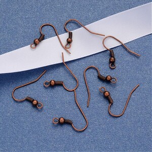 May include: A set of six copper-toned earring hooks. The hooks are made of metal and have a spring-loaded closure. They are perfect for making your own earrings.