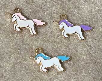 May include: Three gold unicorn charms with white bodies and different coloured manes and tails. The charms have a pink, purple, and blue mane and tail.
