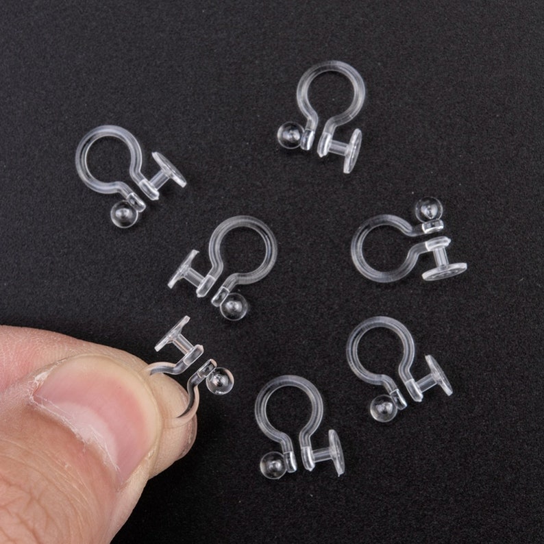 May include: A set of seven clear plastic earring backs. The backs are designed to hold earrings in place and are ideal for people with sensitive ears.