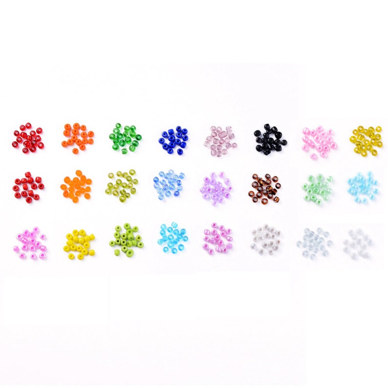 May include: Assortment of 24 small glass seed beads in various colors, including red, orange, yellow, green, blue, purple, pink, brown, black, and white.