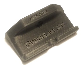 May include: A gray 3D printed QuickLee 3D magazine loader with the text "MADE IN USA" printed on the side.