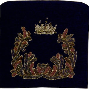 May include: A dark blue velvet kippah with a gold embroidered crown and floral wreath design.