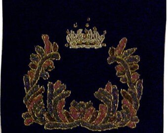 May include: A dark blue velvet kippah with a gold embroidered crown and floral wreath design.