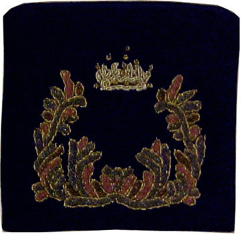 May include: A dark blue velvet kippah with a gold embroidered crown and floral wreath design.