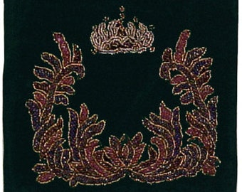 May include: A dark green velvet cushion with a gold and purple beaded design. The design features a crown at the top and a wreath of leaves on either side.