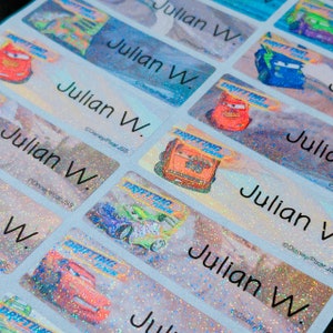May include: A sheet of colorful, glittery name labels with the name "Julian W." repeated multiple times. The labels feature a cartoon image of a red race car with the words "Drifting Fun" on the side.