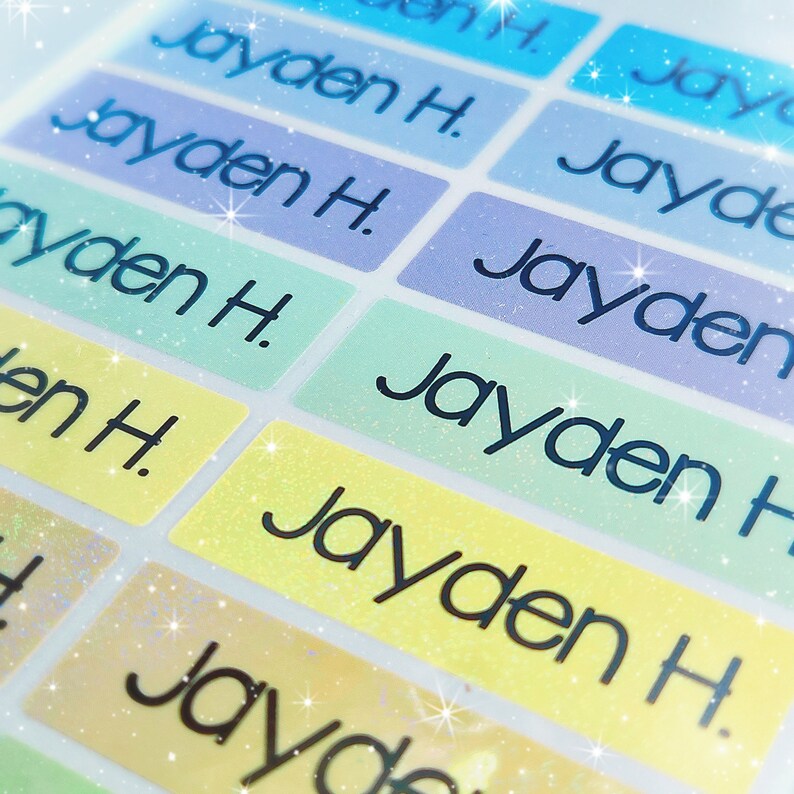 May include: A sheet of colourful, glittery name labels with the name "Jayden H." printed on each label.