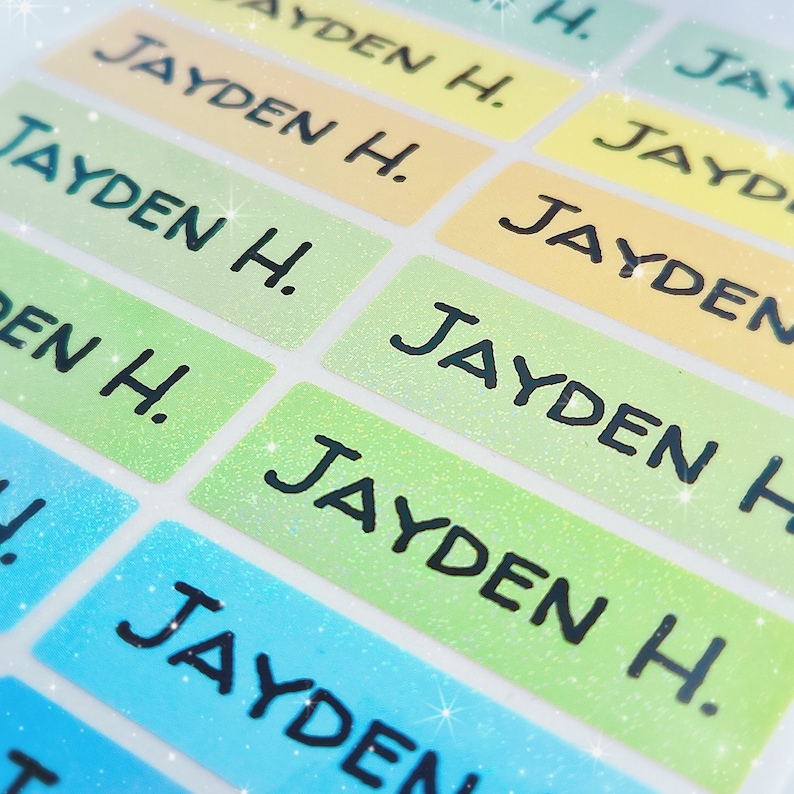 May include: A sheet of colourful, glittery name labels with the name "Jayden H." printed on each label.