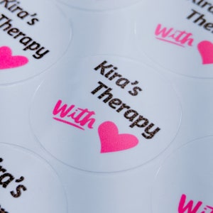 May include: Round white stickers with the text "Kira's Therapy with" and a pink heart.