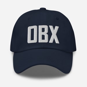 May include: A navy blue baseball cap with a white embroidered "OBX" logo.