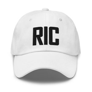 May include: White baseball cap with black embroidered text that reads "RIC".