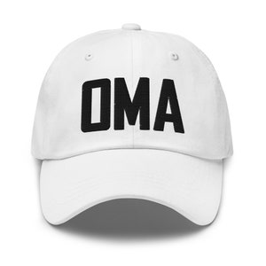 May include: White baseball cap featuring the word "OMA" embroidered in black. The cap has a curved peak and an adjustable strap. A simple, everyday accessory.