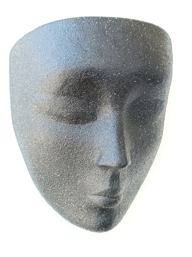 This is an exclusive design cement wall planter in the shape of a beautiful woman's face. It is in black stone color and has grainy texture to the touch. This wall planter is intended for indoor or covered outdoor use. Drainage hole in place.