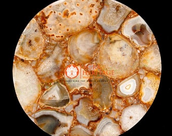 May include: A round, polished stone surface with a mosaic pattern of beige, brown, and white agate pieces. The agate pieces are outlined with a golden-brown material. The image includes the text "GR Heritage Marble Crafts" and "ENRICHING THE WORLD AROUND YOU."