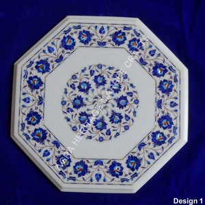 May include: Octagonal white marble table top with intricate floral design inlaid with blue, turquoise, and gold colored stones.  Design 1.