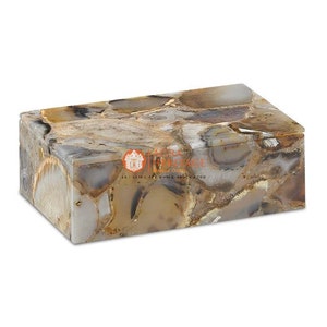 May include: Rectangular agate box with a lid. The box features a mosaic pattern of beige, gray, and brown tones. The box is made of natural stone and has a polished finish. The box is a decorative item.
