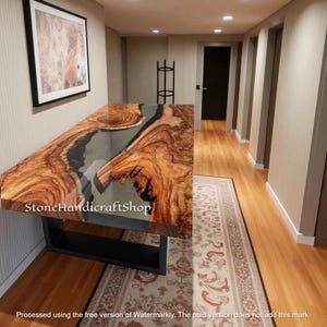 May include: A handcrafted wooden table with a live edge design. The table features a natural wood grain pattern with a clear epoxy resin inlay. The base is made of black metal. The text "Stone Handicraftshop" is visible on the table.