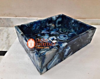 May include: Blue agate stone sink with a rectangular shape. The sink has a natural, swirling pattern of blue and white agate. The sink is made of natural stone and has a unique, handcrafted look.