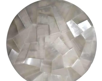 May include: A round, white, decorative tray made of mother of pearl tiles. The tiles are arranged in a geometric pattern.