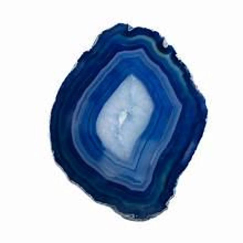 May include: A polished, oval-shaped blue agate stone slice. The stone features concentric bands of varying shades of blue, with a central, lighter-colored crystalline area. The outer edge has a natural, uneven texture.