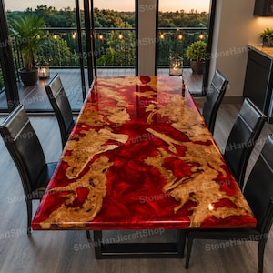 May include: A rectangular dining table featuring a live edge wood slab embedded in a glossy, deep red resin surface. The table is supported by a black metal frame and is surrounded by six black leather chairs with high backrests.