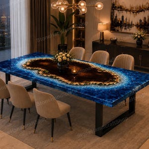 May include: A rectangular dining table featuring a central dark brown wood slab surrounded by a vibrant blue resin border that mimics the appearance of ocean waves. The table is supported by black metal legs and paired with six beige chairs.