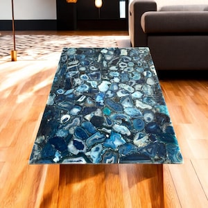 May include: A blue agate coffee table with a unique, natural stone top. The table has a modern design and would be a great addition to any living room.
