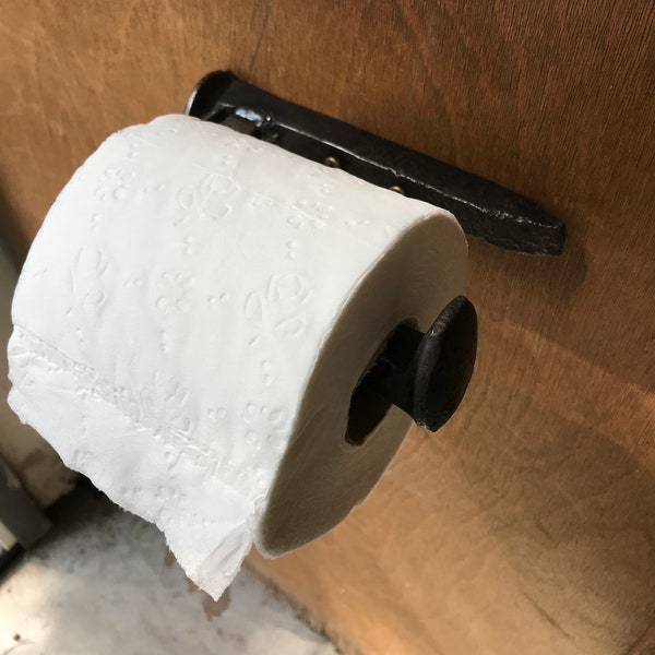 Railroad spike toilet paper holder