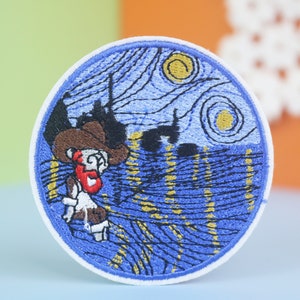 May include: A round embroidered patch featuring a blue and yellow rendition of Vincent van Gogh's "Starry Night" painting. A cartoon character with a red nose and brown hat is standing in the foreground.
