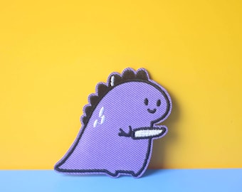 Purple Dinosaur Holding Knife Embroidered Iron-On Patch