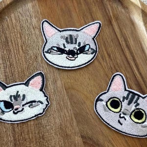 Embroidered Cat Face Iron On Patch, Kitty Expression Schming Winking Crying