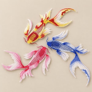 May include: Three embroidered koi fish patches featuring detailed scale patterns and flowing fins. One patch is yellow and red, one is blue and white, and one is pink and white. Each fish has two long barbels extending from the mouth area.