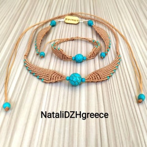 May include: A set of three handmade macrame necklaces with turquoise beads. The necklaces are made with brown cord and feature a unique woven pattern. The set includes a long necklace, a shorter necklace, and a bracelet.