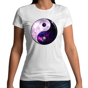May include: White t-shirt with a black and white yin yang symbol. The yin yang symbol is filled with a galaxy-like pattern of purple, blue, and white.