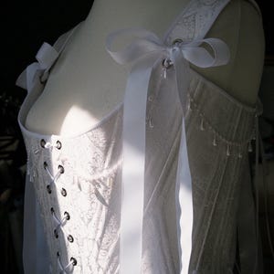 white satin jacquard renaissance corset with lace up front and back, structured overbust bodice with boning and optional straps