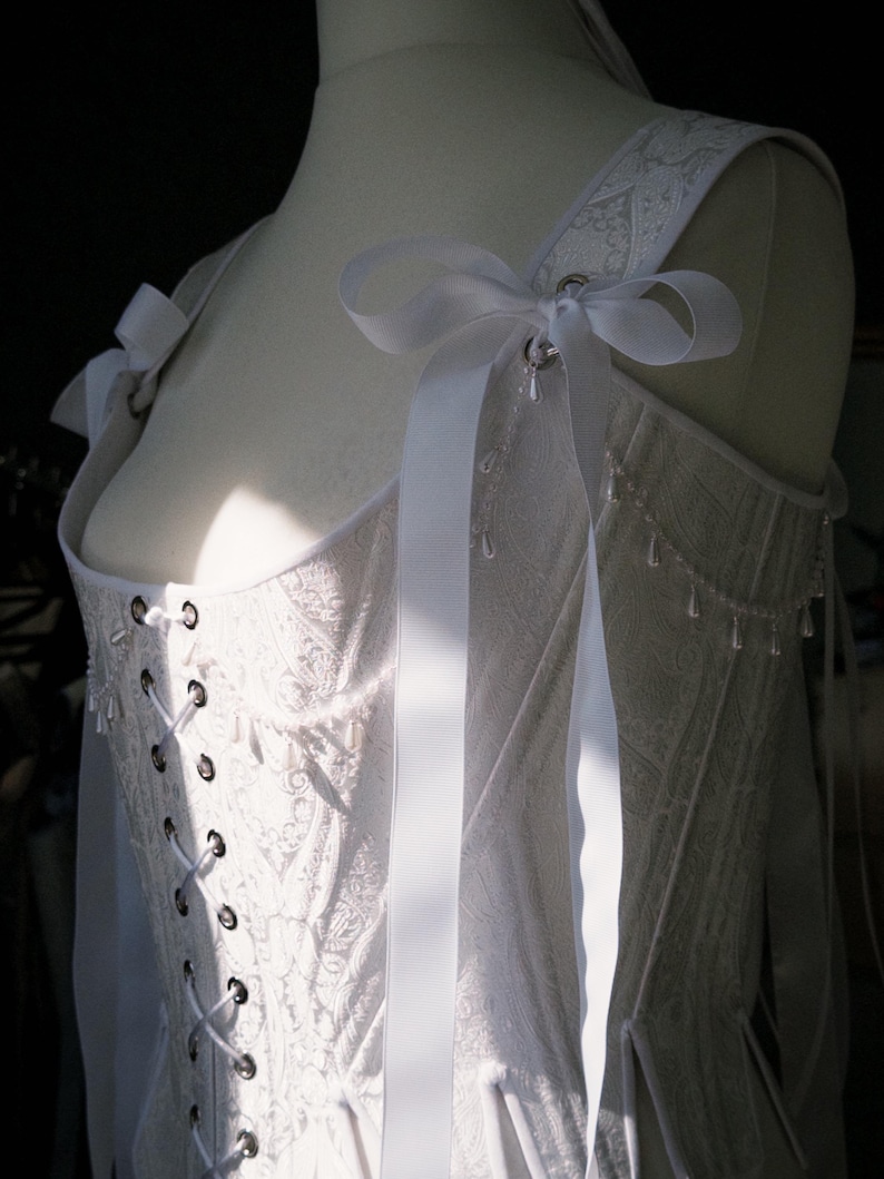 white satin jacquard renaissance corset with lace up front and back, structured overbust bodice with boning and optional straps