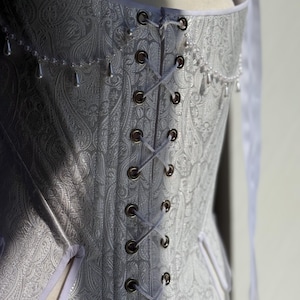 white satin jacquard renaissance corset with lace up front and back, structured overbust bodice with boning and optional straps
