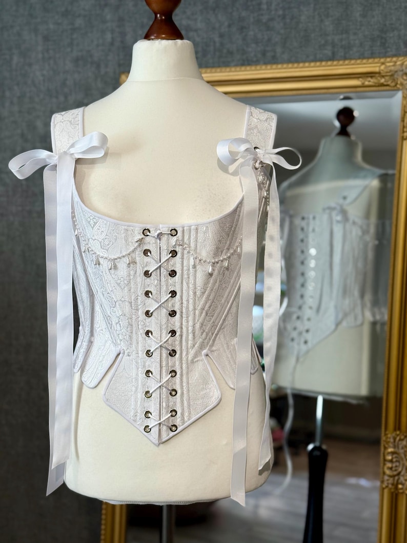 white satin jacquard renaissance corset with lace up front and back, structured overbust bodice with boning and optional straps