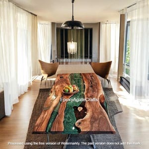 May include: A large wooden dining table with a green epoxy resin river running through the center. The table is in a modern dining room with white curtains and a glass chandelier.