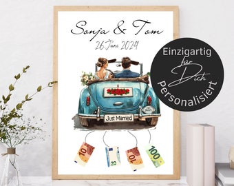 May include: A wedding card with a blue car and a bride and groom inside. The car has a "Just Married" sign on the back. The card is decorated with money hanging from the car.