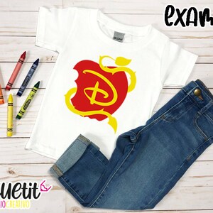 Puede incluir: Camiseta blanca con un dise&ntilde;o de manzana roja con una "D" estilizada amarilla en su interior. La manzana tiene vides y hojas amarillas. La camiseta se combina con unos vaqueros azules.