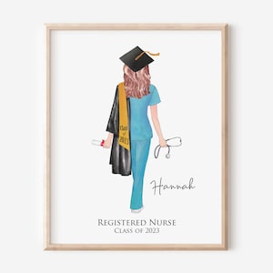 May include: A framed illustration of a graduate in light blue scrubs, wearing a black graduation cap and gown with a gold stole labelled Class of 2023. The figure holds a diploma and a stethoscope, with the name Hannah and Registered Nurse Class of 2023.