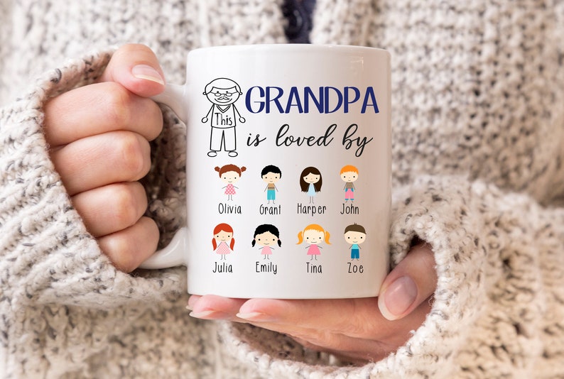 May include: White ceramic mug with a black and white illustration of a person with the text "Grandpa is loved by" and a row of eight black and white illustrations of children with names below each illustration. The names are Olivia, Grant, Harper, John, Julia, Emily, Tina, and Zoe.